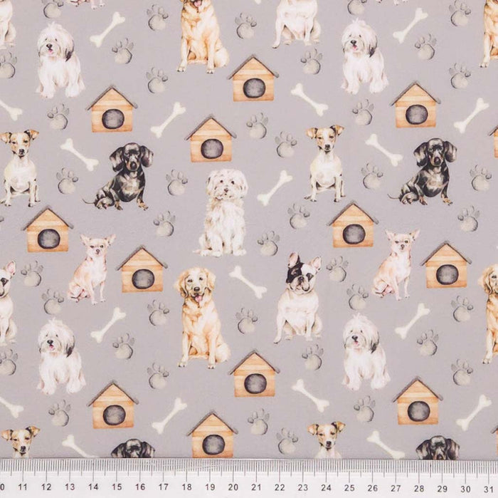 Dogs printed on a grey polycotton fabric with a cm ruler