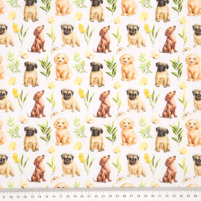 Dogs of various breeds printed on a white polycotton fabric with a cm ruler