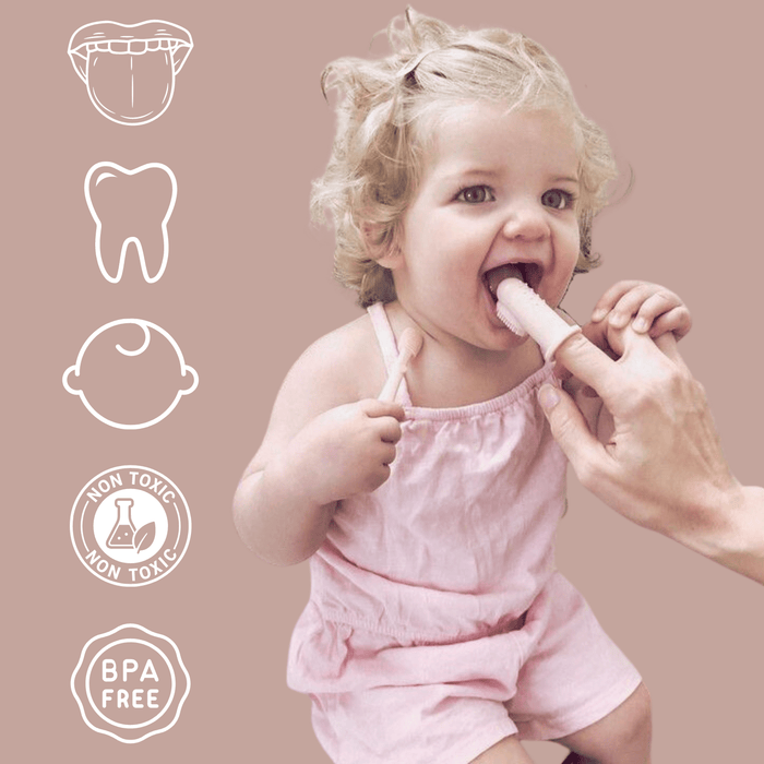 Young child being gently introduced to oral hygiene by an adult using a baby toothbrush