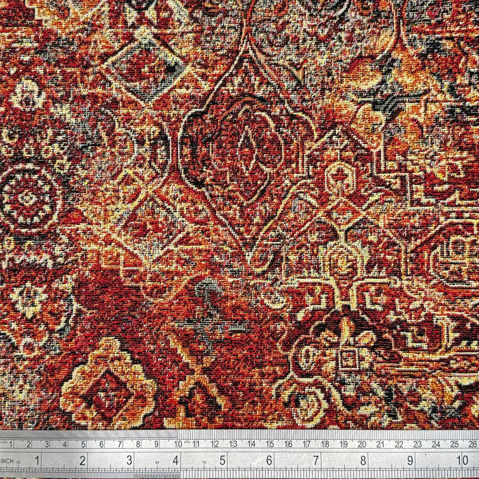 A baroque design printed on tapestry upholstery fabric with a cm ruler