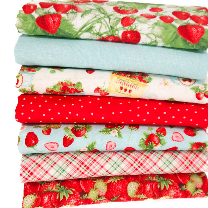 A strawberry themed fat quarter bundle of 7 fabrics in reds and turquoise