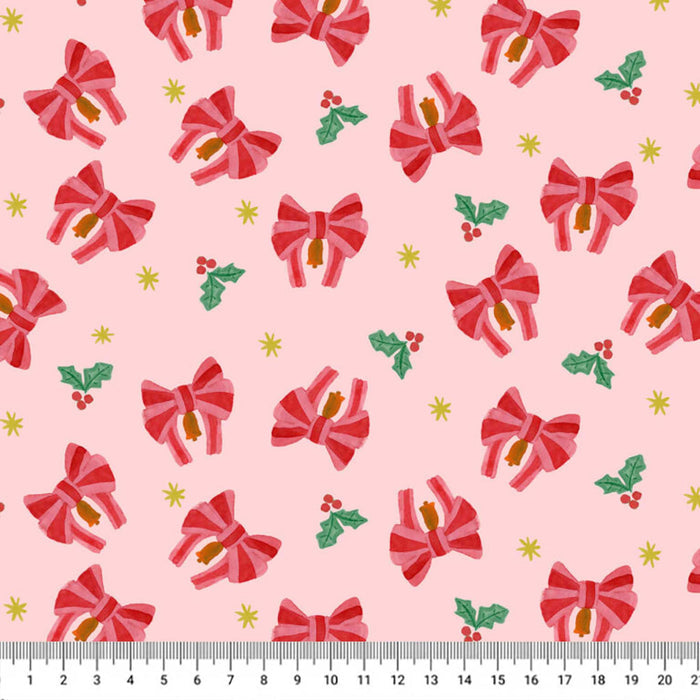 A repeating Christmas-themed pattern on a light pink background, featuring red striped bows, green holly leaves with red berries, small yellow stars, and a white ruler along the bottom edge showing scale.