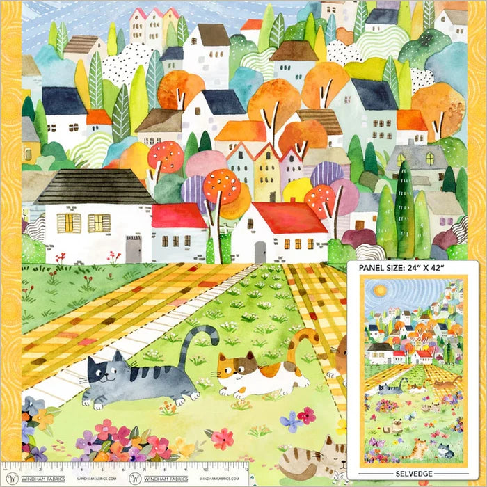 Colorful fabric panel with a village scene, cats, and flowers.