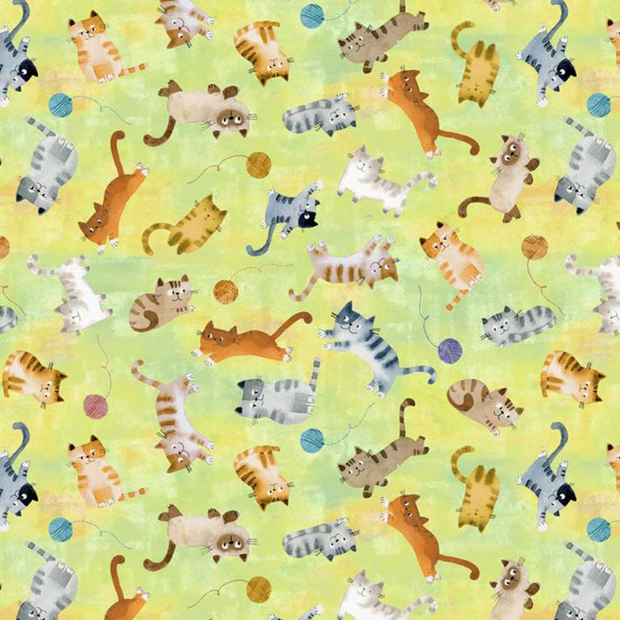 Pattern of cartoon cats and yarn balls on a yellow quilting fabric