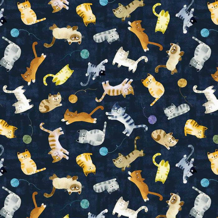 Pattern of cartoon cats on a dark blue quilting fabric