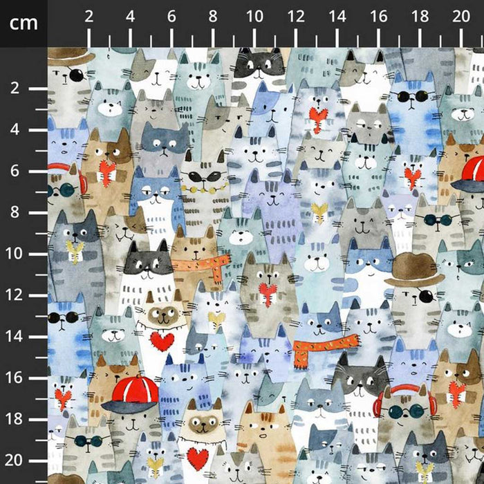 Pattern of cartoon cats on a fabric with a ruler for scale.