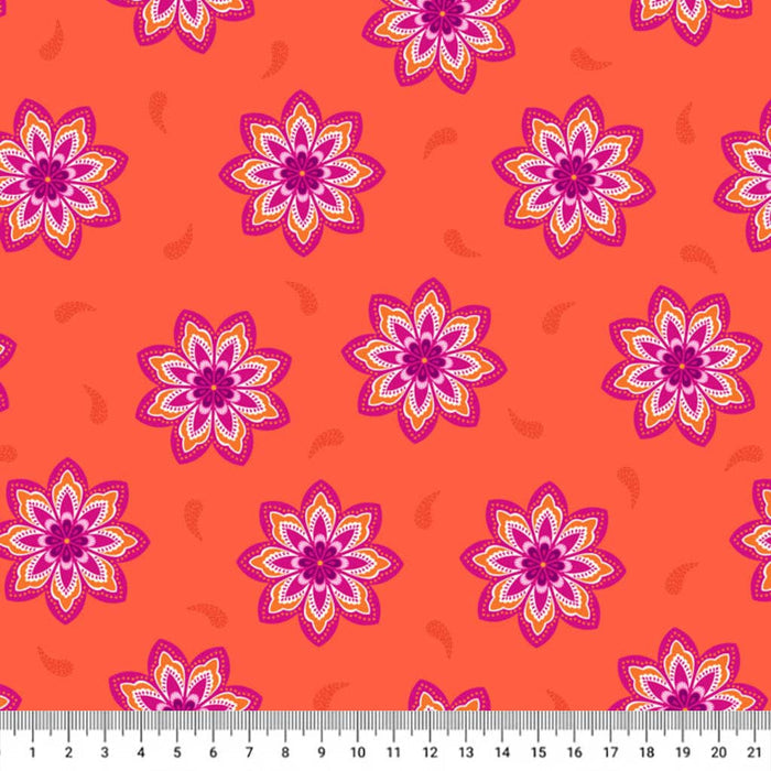 Magenta flowers on an orange cotton quilting fabric with a cm ruler