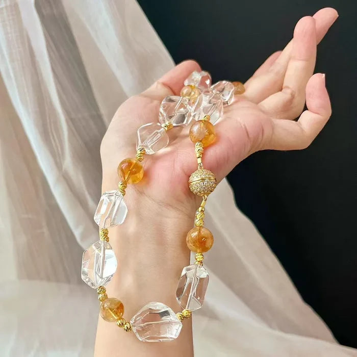 Citrine and Clear Quartz choker held in hand showing alternating beads and gold wire wrapping, Crystalvana