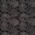 A repeating Halloween-style pattern of white spiderwebs and small spider silhouettes on a black cotton fabric.