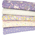 A fat quarter bundle of spring themed fabrics in blues and creams