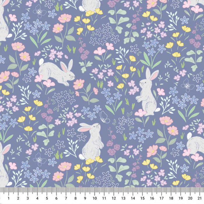 Bunnies printed on a blue cotton quilting fabric with a cm ruler