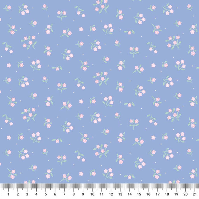 Floral pattern on a blue cotton quilting fabric with a ruler at the bottom.