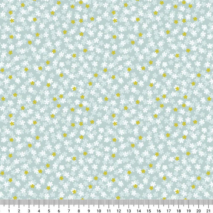 Pattern of small white flowers and yellow dots on a light blue background with a ruler at the bottom.