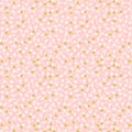 Pattern of small white flowers with green centers on a pink cotton quilting fabric