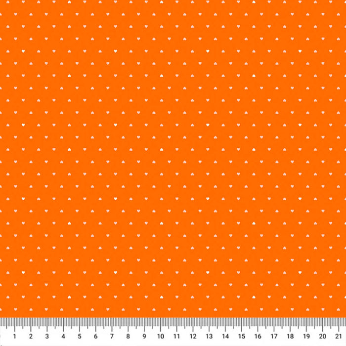 Ditsy hearts on orange cotton fabric with a cm ruler