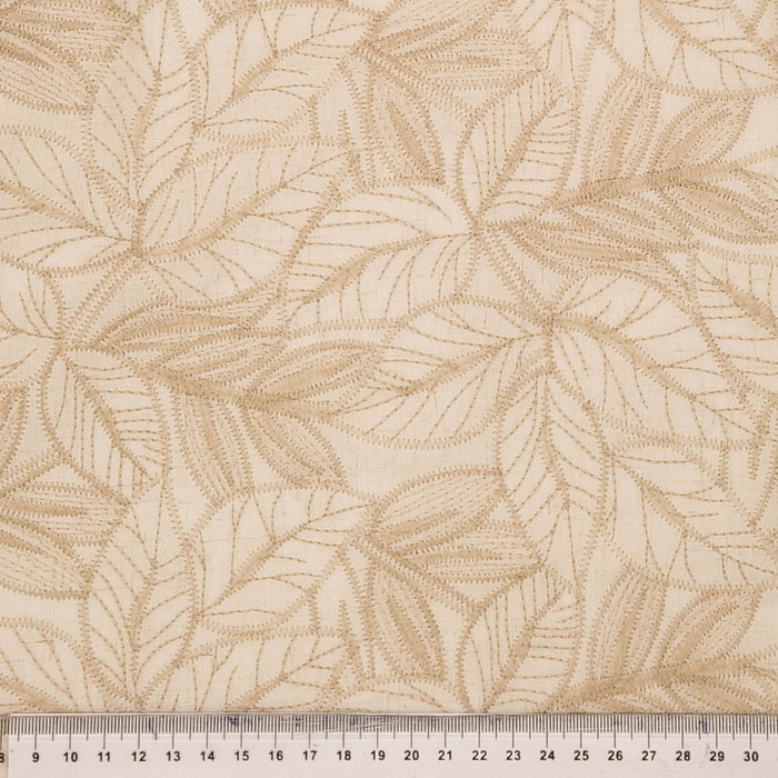 Textured fabric with leaf pattern and a ruler at the bottom for scale.