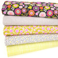 Stack of colorful floral and checkered fabrics on a white background