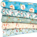 A fat quarter bundle featuring robins and holly in blue and cream