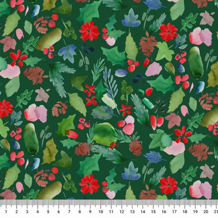 A close-up of a green fabric with a dense watercolor floral and botanical print, featuring red, pink, blue, and green leaves and flowers. A white fabric ruler is visible along the bottom edge to show scale.