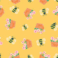 Pattern of bees, beehives, and flowers on a yellow cotton quilting fabric