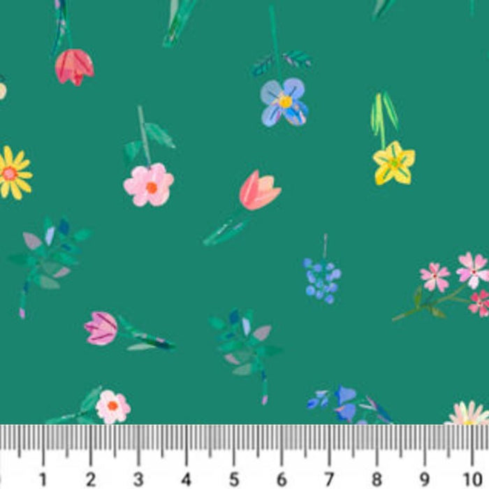 Floral pattern on a green cotton quilting fabric with a ruler at the bottom