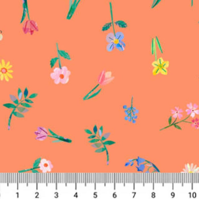 Floral pattern on an orange cotton quilting fabric with a ruler at the bottom