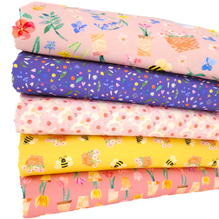 A fat quarter bundle of quilting fabrics with florals and bees