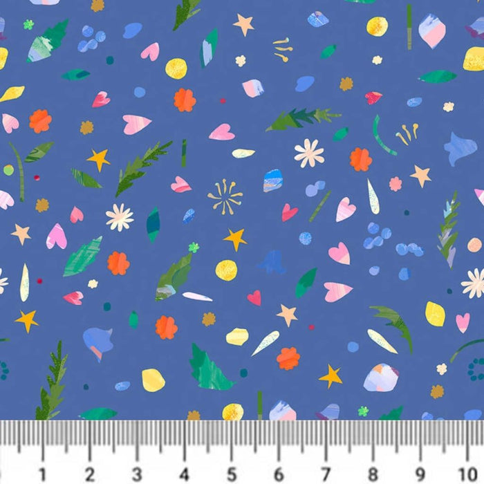 Colourful patterned fabric with a ruler at the bottom for scale on a blue background
