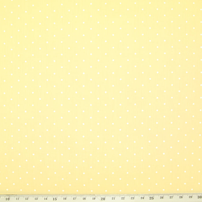 White pin spots on a yellow polycotton fabric