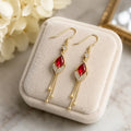 French design red crystal cat's eye drop earrings on pink cushion, Crystalvana