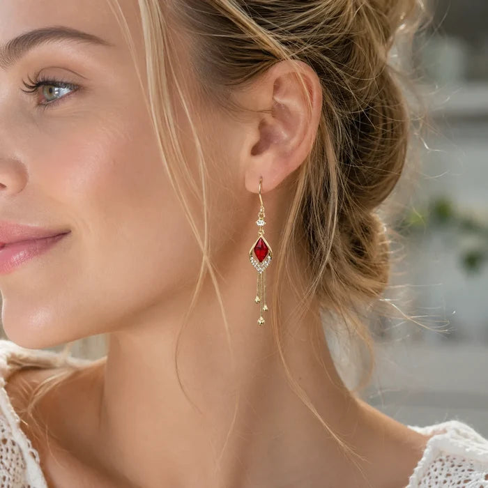 Model wearing French design red crystal cat's eye earrings blonde low bun side profile portrait, Crystalvana