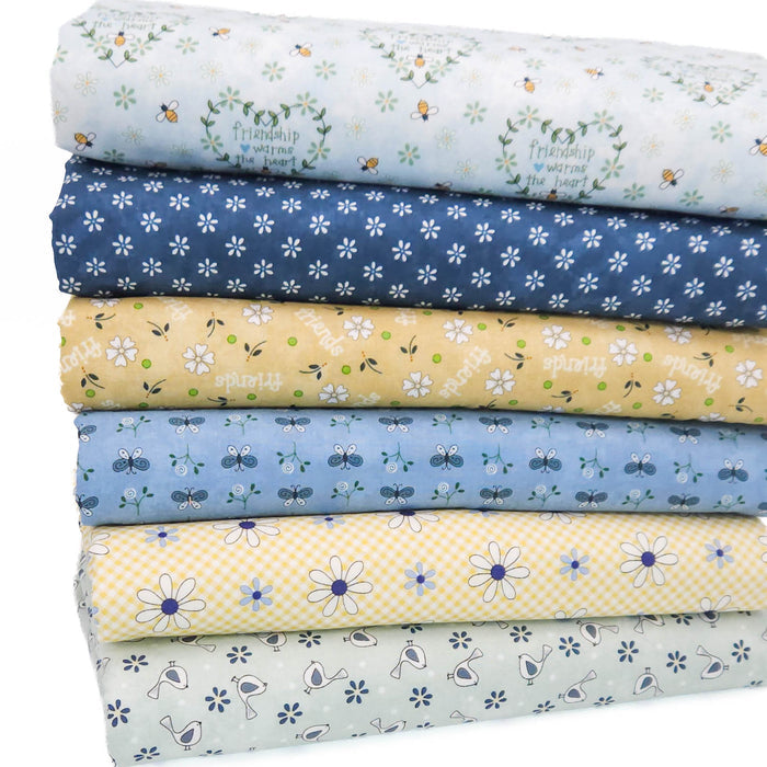 A stack of six fat quarters of fabric with various floral and insect patterns in pastel colors, including blue, yellow, and light green, on a white background.