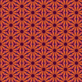 A floral geometric pattern in reds and oranges printed on a cotton quilting fabric