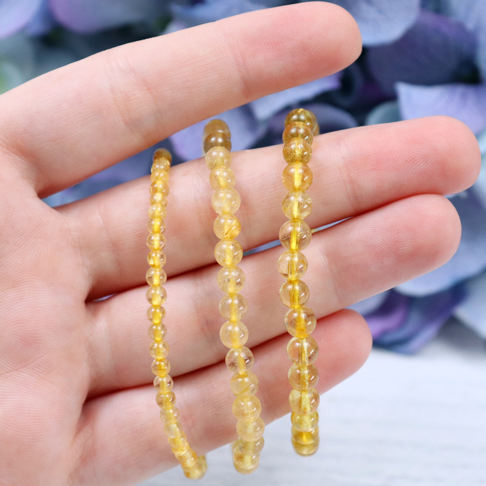 Close-up of natural Gold Rutilated Quartz beads showing colour and pattern