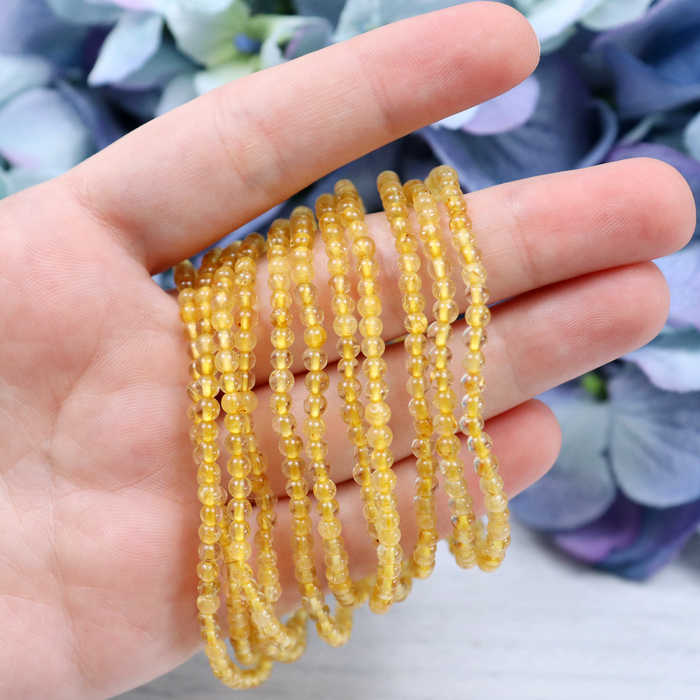 Gold Rutilated Quartz crystal bracelet stacked with other Crystalvana pieces
