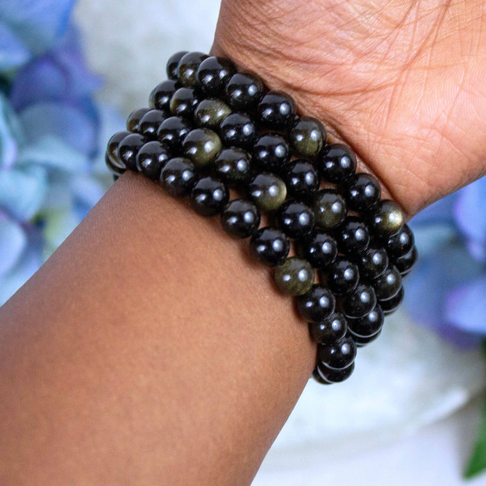 Close-up of natural Gold Sheen Obsidian beads showing colour and pattern