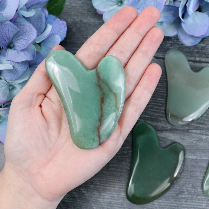 Green Aventurine gua sha tool in its Crystalvana storage pouch