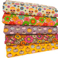 Stack of colourful fat quarters with floral and pumpkin patterns