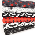 A halloween themed fat quarter bundle with spiders and bats in black, red and white