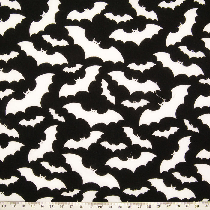 White bats printed on a black halloween polycotton fabric