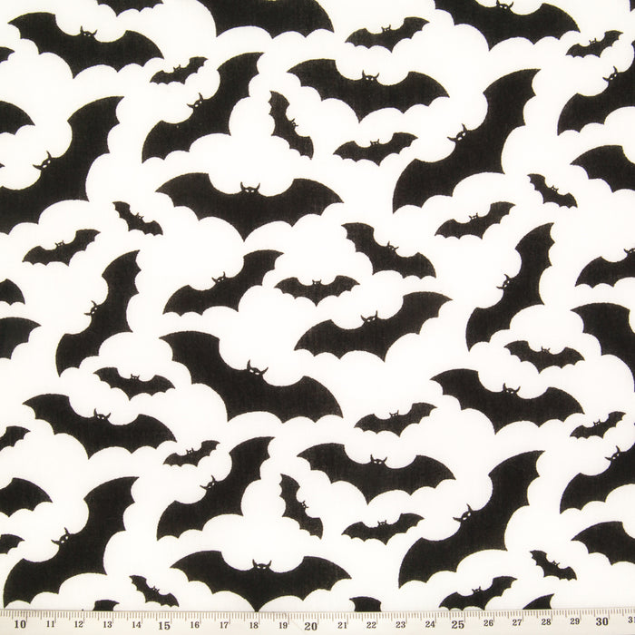 Black bats printed on a white halloween polycotton fabric