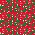 A repeating Christmas holly pattern featuring green holly leaves and small cream-colored berries on a solid red cotton quilting fabric.