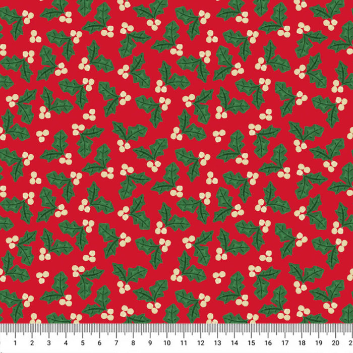 Red fabric with a repeating green holly and white berry pattern, shown flat with a white ruler along the bottom edge for scale.