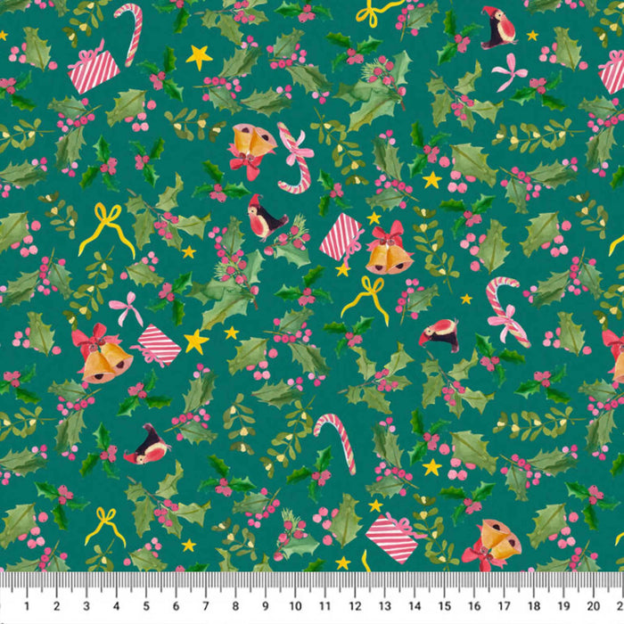 A close-up of a festive Christmas patterned fabric with a ruler scale at the bottom. The fabric features a teal green background decorated with holly leaves, red berries, candy canes, bells, stars, bows, and small birds.