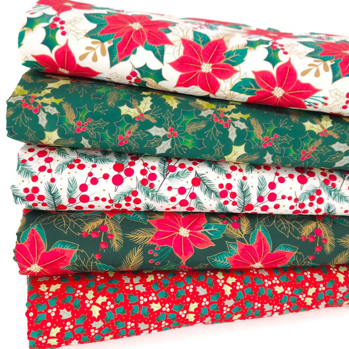 Fat quarter bundle of Christmas-themed fabrics with poinsettias and holly leaves.