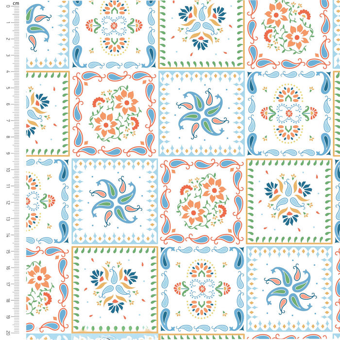 Patterned fabric with colorful designs on a white background, featuring a ruler for scale.