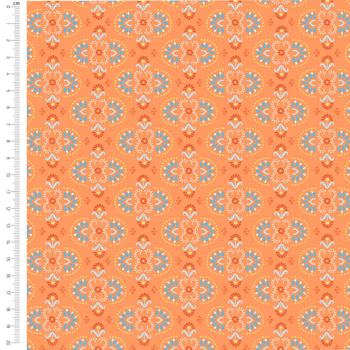 Patterned fabric with geometric designs on an orange background, shown with a ruler for scale.