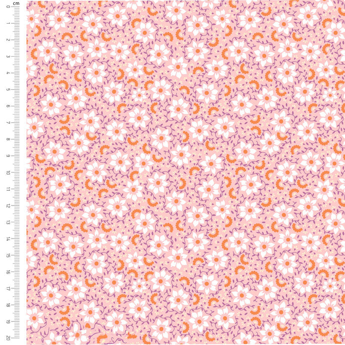 Floral pattern fabric swatch on a pink background with a ruler for scale.