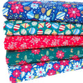 A fat quarter bundle with brightly coloured christmas themed fabrics
