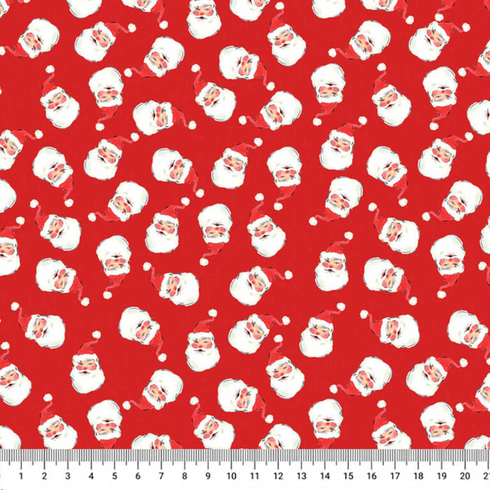 Red fabric with a repeating pattern of white Santa Claus faces, shown flat with a ruler along the bottom edge for scale.